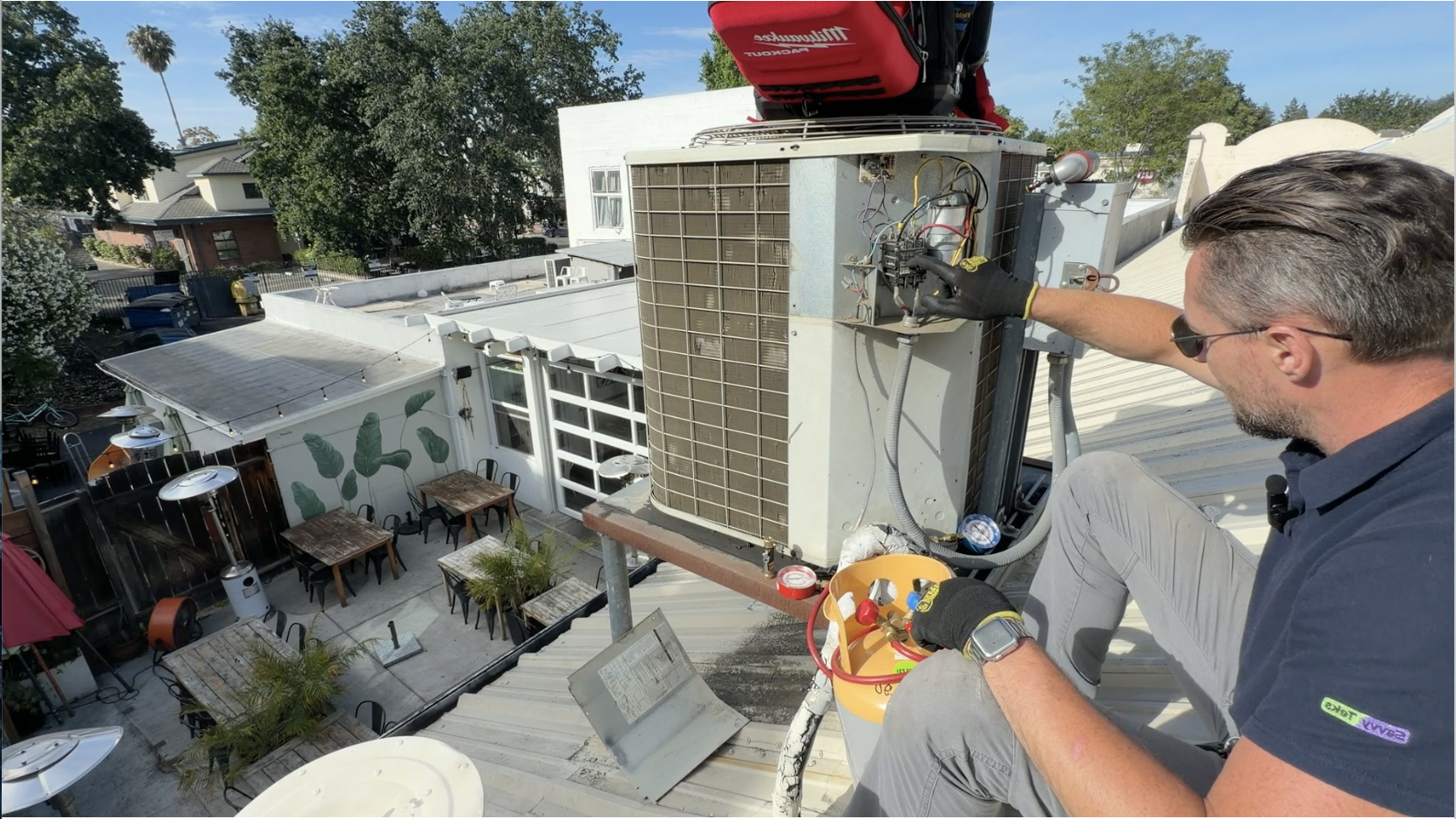 HVAC technician servicing an outdoor AC unit in San Ramon